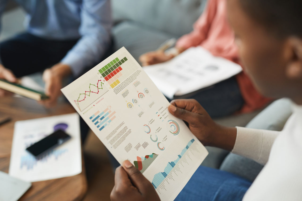 Businessperson analyzing colorful data charts in office