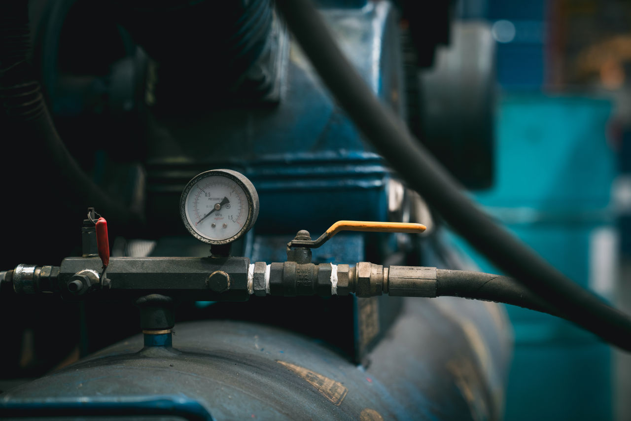 Close-up of industrial pressure gauge on machinery