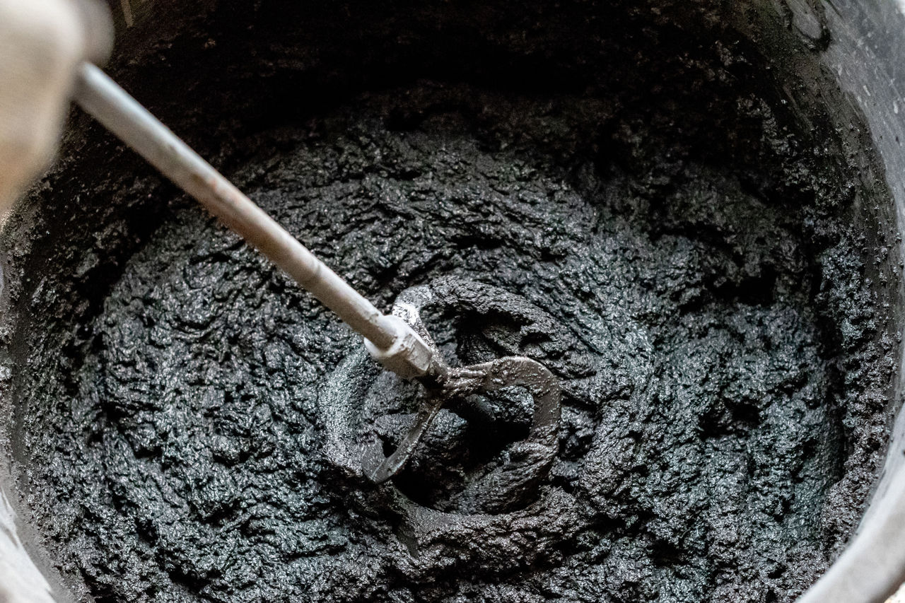 Close-up of wet cement mixture being stirred