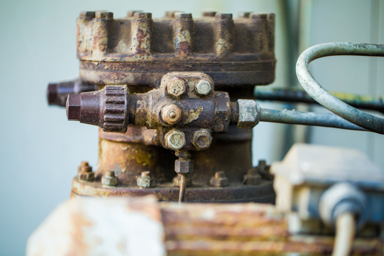 Close up of old industrial valve and piping system