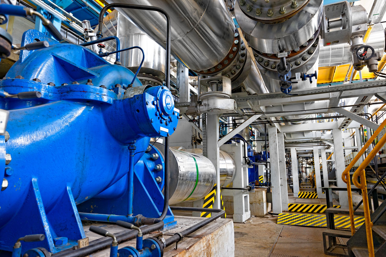 Industrial facility with large blue machinery and pipes
