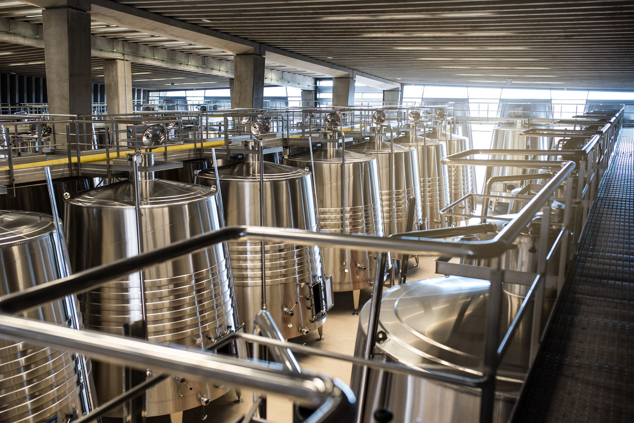 Modern stainless steel fermentation tanks in industrial facility