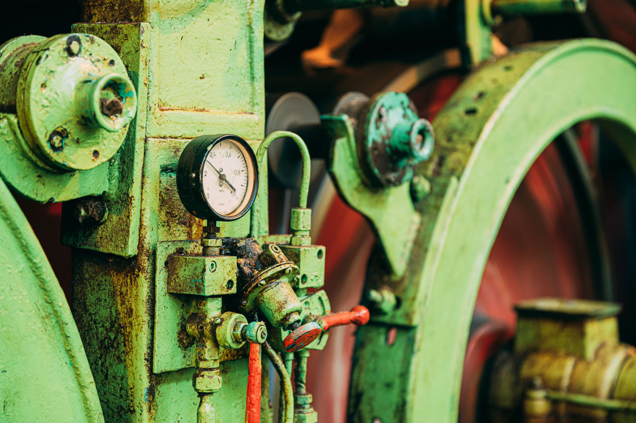 close-up of vintage industrial machine with gauge