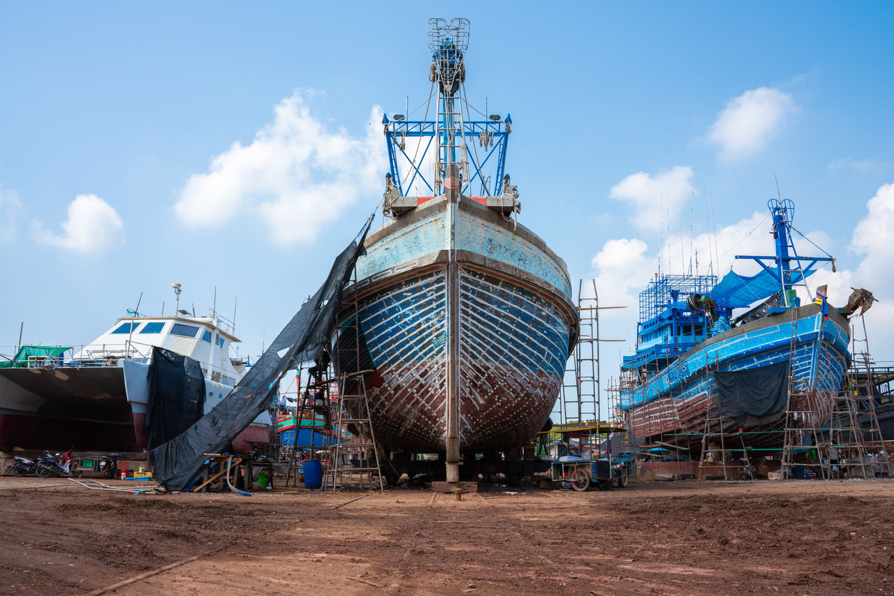Large fishing boats under repair at shipyard dock