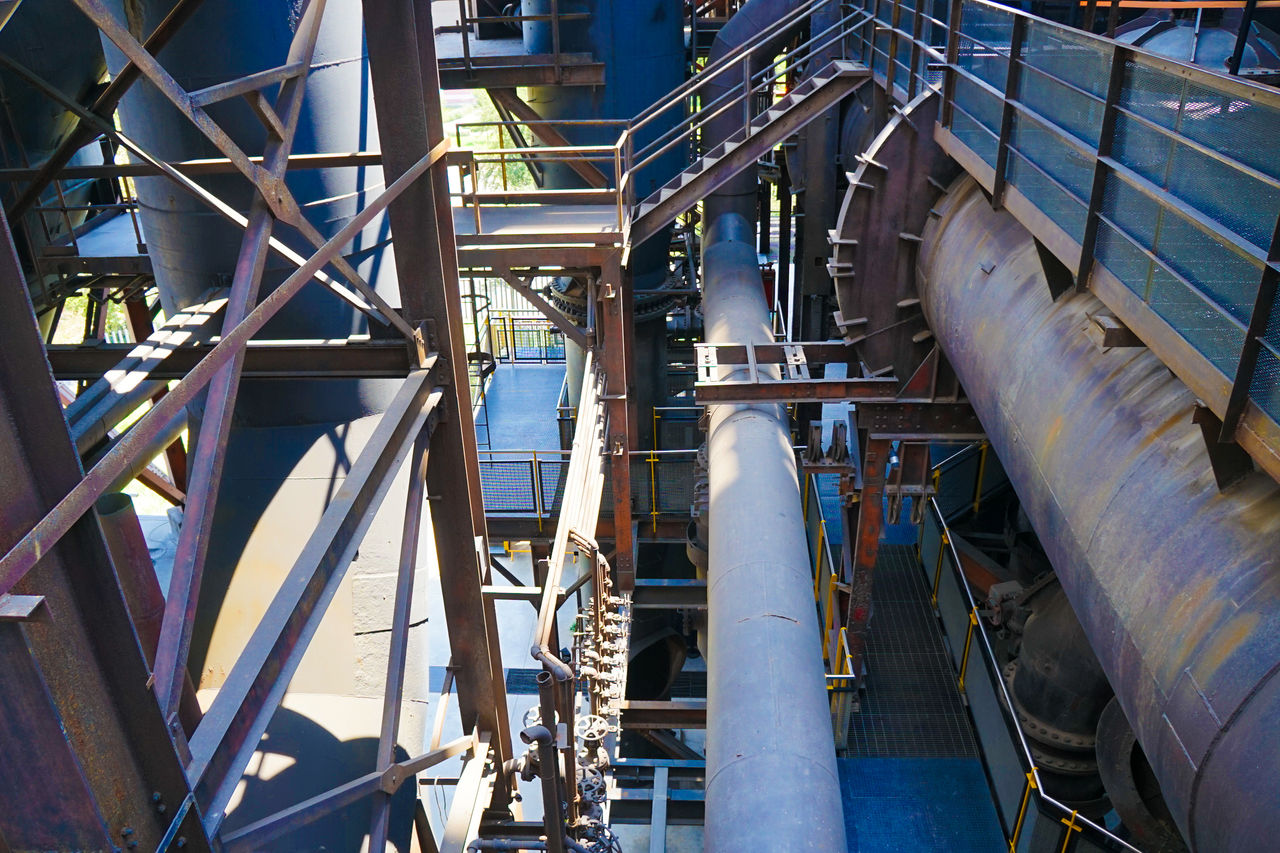 Industrial facility with large metal pipes and walkways
