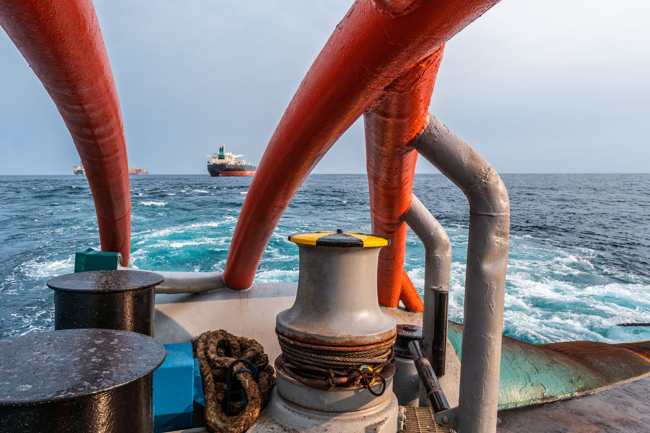 Oil spill response vessel at sea with containment boom