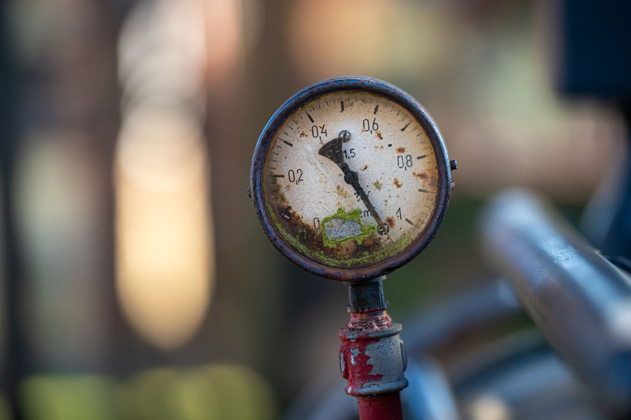 Rusty analog pressure gauge with weathered dial